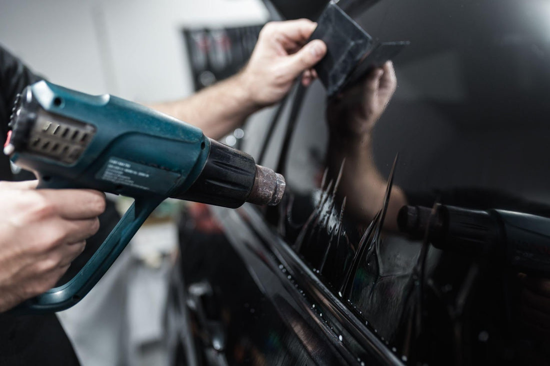 Mechanic using power drill to repair vehicle